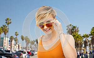 Portrait of smiling young woman in sunglasses