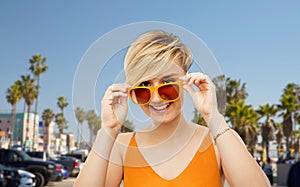 Portrait of smiling young woman in sunglasses