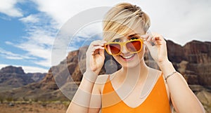 Portrait of smiling young woman in sunglasses