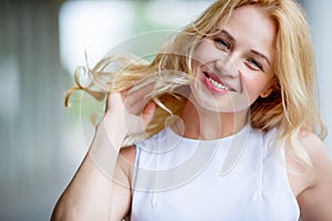 Portrait of smiling young woman touching her hair