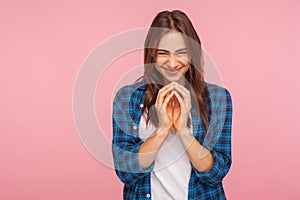 Portrait of sneaky scheming young woman in checkered shirt thinking devious plan with cunning evil face