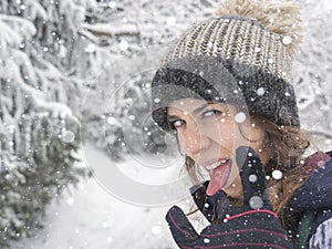 Portrait of snowboarder girl on the background of snow forest