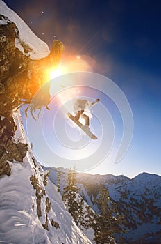 Portrait of snowboarder jumping from mountain ledge