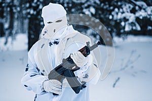 Portrait of soldier in camouflage and white mask balaclava with