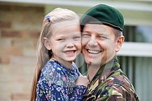Portrait Of Soldier On Leave Hugging Daughter