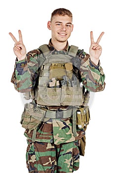 Portrait soldier or private military contractor showing victory gesture .