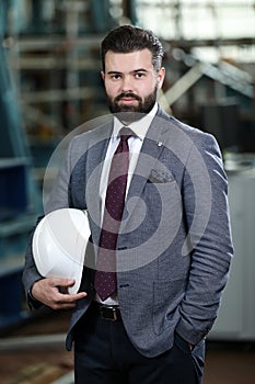 Portrait of a solid businessman controlling work process in a airplane manufactory.