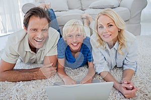 Portrait of son and parents using a laptop