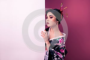 Portrait of sophisticated elegant korean girl presenting empty space special sale on pink color gradient background