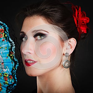 Portrait of spanish girl flamenco dancer with fan