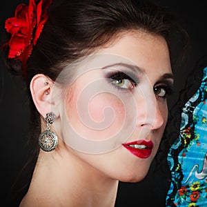 Portrait of spanish girl flamenco dancer with fan