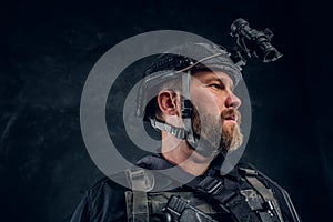 Portrait of a special forces soldier wearing body armor and helmet with a night vision.