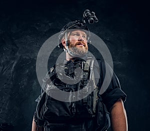 Portrait of a special forces soldier wearing body armor and helmet with a night vision.