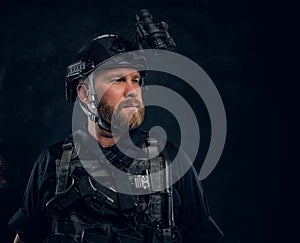 Portrait of a special forces soldier wearing body armor and helmet with a night vision.