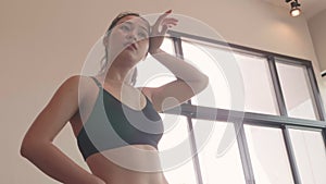 Portrait of sport Asian woman resting and relax after relax breaking from workout weight cardio training in fitness sport gym with