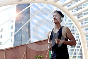 Portrait sport runner handsome man with headphones running outside, exercise run outdoor, male jogger athlete training and doing