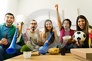 Portrait of sports fans cheering for their favorite sports team