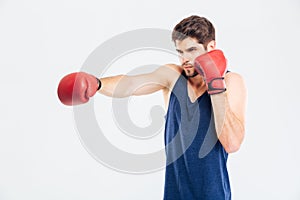 Portrait of a sports man boxing in red gloves