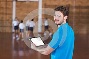 Portrait of sports teacher using digital tablet