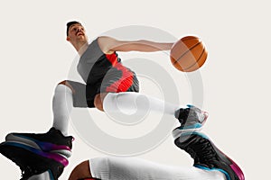 Portrait of sportsman wearing special clothes playing with ball over white background