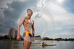 Portrait of a sporty, athletic, muscular man in swimtrunks