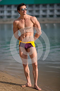 Portrait of a sporty, athletic, muscular man in swimtrunks