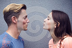 Portrait of sporty couple blowing kisses