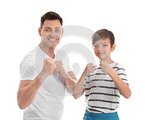 Portrait of sporty dad and his son on white