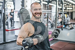 Portrait of sporty healthy strong muscle charismatic happy smiling handsome man bodybuilder hard training workout in well-equipped