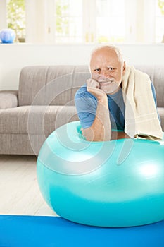 Portrait of sporty senior man with exercise ball