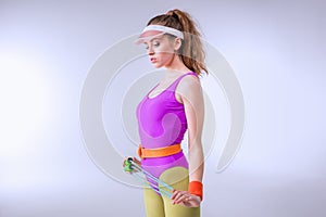 Portrait of sporty woman holding skipping rope