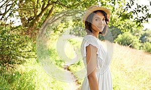 Portrait, spring or happy woman in park, countryside or nature environment to relax on break. Smile, wellness or person