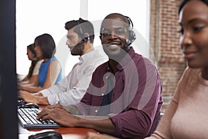 Portrait Of Staff In Busy Customer Service Department Shot