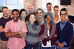 Portrait Of Staff Standing In Modern Design Office