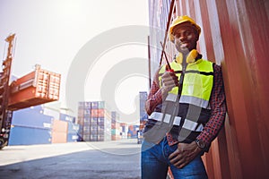 Portrait staff worker happy smile working in cargo shipping logistic port hand holding radio control