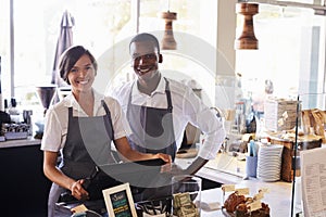 Portrait Of Staff Working At Delicatessen Checkout