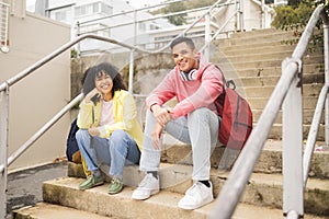 Portrait, stairs and students with a man and black woman sitting outdoor on campus together at university for education