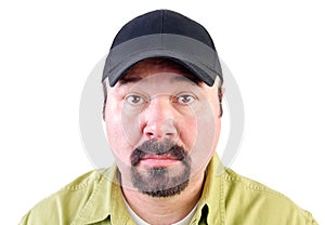 Portrait of staring man wearing baseball cap