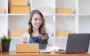 Portrait of Starting small businesses SME owners female entrepreneurs working on receipt box and check online orders to