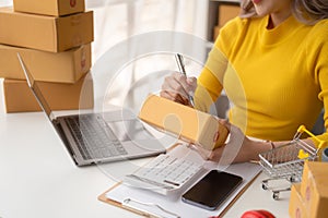 Portrait of Starting small businesses SME owners female entrepreneurs working on receipt box and check online orders to prepare to