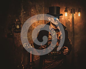 Portrait of steampunk man with various mechanical devices on vintage steampunk background