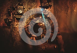 Portrait of steampunk man with various mechanical devices on vintage steampunk background