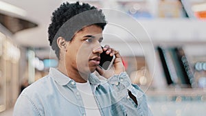 Portrait stressed african man hearing awful news at mobile phone call conflict stress quarrel with girlfriend remote
