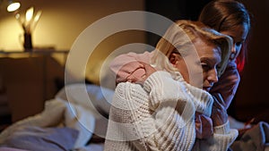 Portrait of stressed anxious mother and daughter get scared as red air-raid alert warning lamp flashing at background