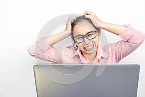 Close up portrait of stressed Asian woman, wearing glasses, looking tablet with seriously face and have headach symtom, sitting photo