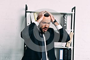 portrait of stressed businessman in suit looking away