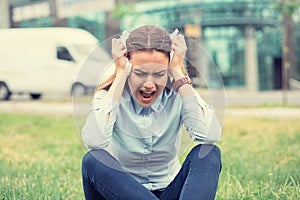 Portrait stressed crying screaming young woman outdoors near corporate office. Urban life style job related stress