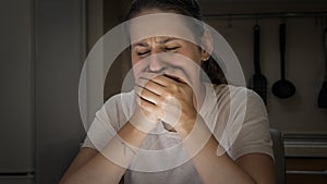 Portrait of stressed crying woman holding her scream with hands