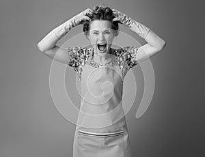 Portrait of stressed modern woman in apron on