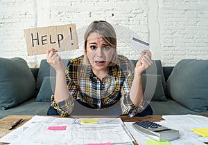 Portrait of stressed and overwhelmed young woman with too much credit card debts